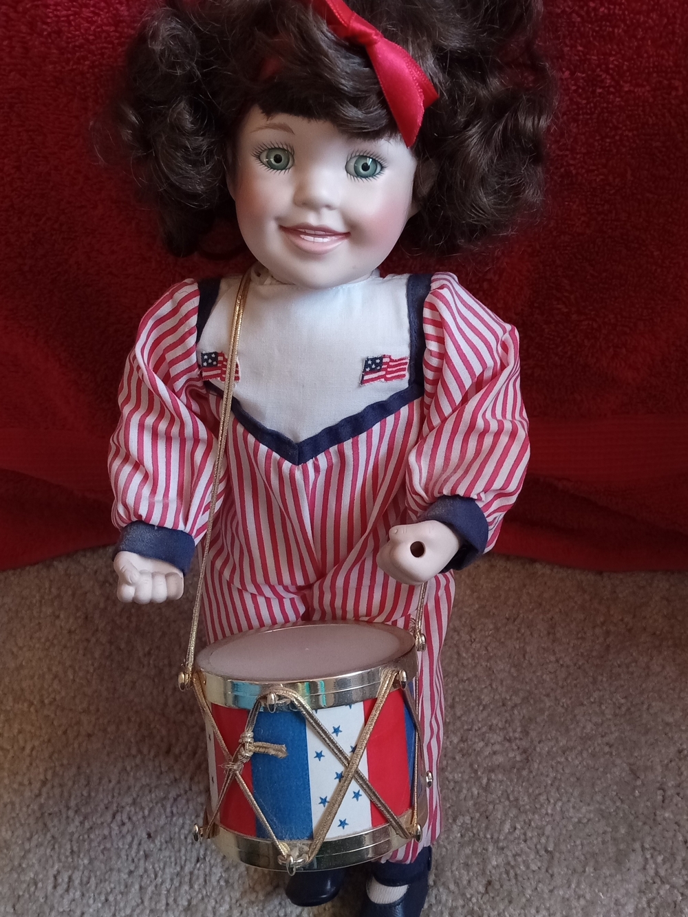 Porcelain Doll in Red and White Striped Outfit with Toy Drum